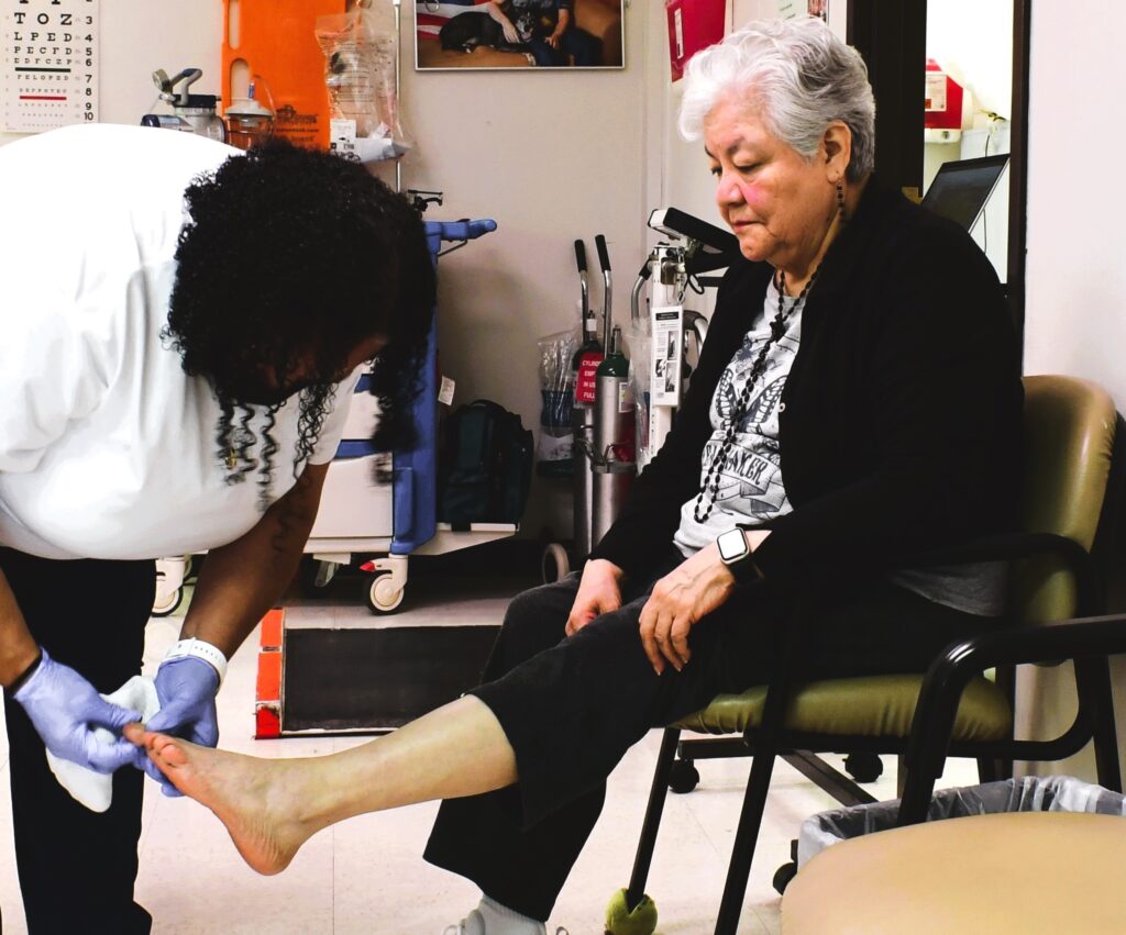 PACE participant getting foot check by medical staff